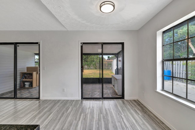empty room with baseboards and wood finished floors