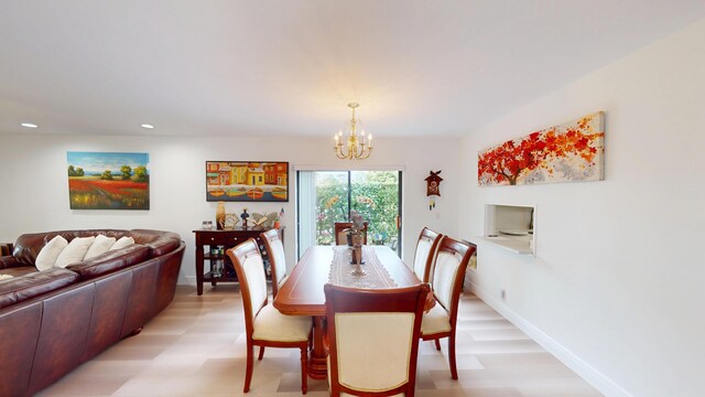 dining area featuring recessed lighting, baseboards, a notable chandelier, and light wood finished floors