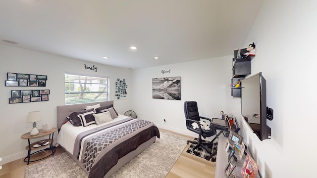 bedroom featuring wood finished floors, recessed lighting, and baseboards