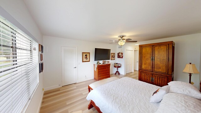 bedroom featuring light wood-style floors, baseboards, and ceiling fan