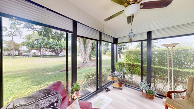 unfurnished sunroom with a ceiling fan