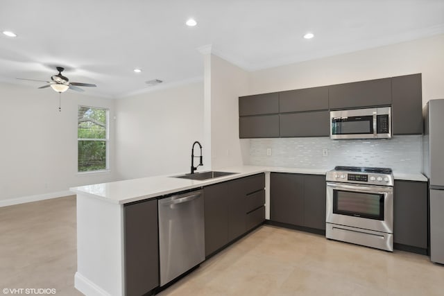 kitchen featuring a sink, a peninsula, modern cabinets, and stainless steel appliances