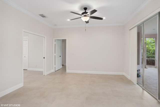 empty room featuring ceiling fan, baseboards, visible vents, and ornamental molding