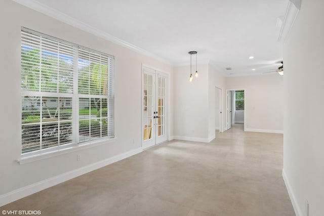 empty room featuring plenty of natural light, french doors, crown molding, and baseboards