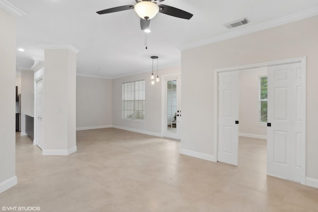 spare room with a ceiling fan, baseboards, visible vents, and ornamental molding