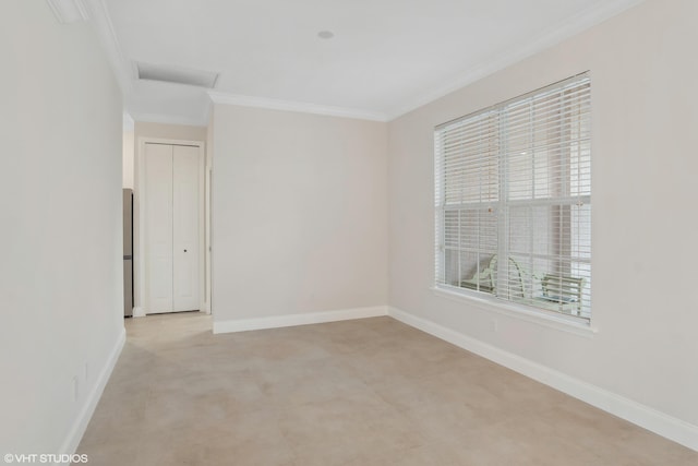 empty room featuring baseboards and crown molding