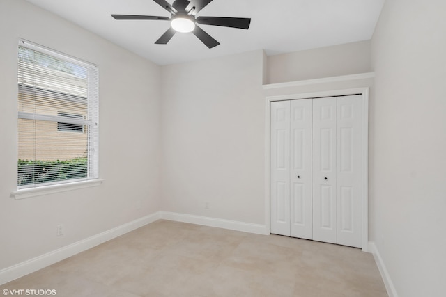 unfurnished bedroom with a closet, a ceiling fan, and baseboards