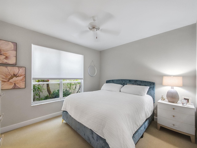 bedroom with carpet flooring, a ceiling fan, and baseboards