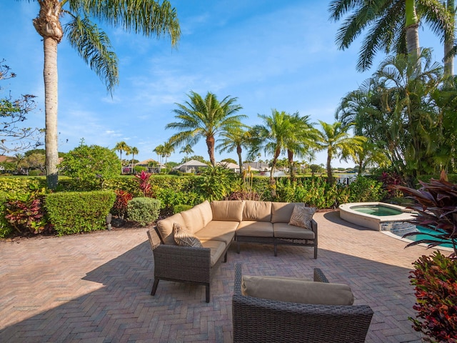 view of patio with outdoor lounge area and an in ground hot tub