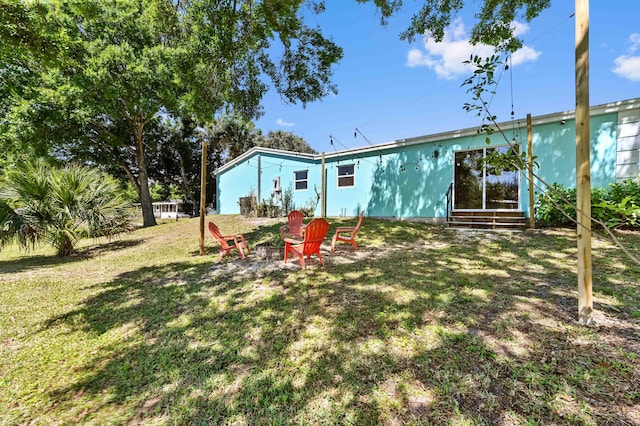 back of house with a lawn