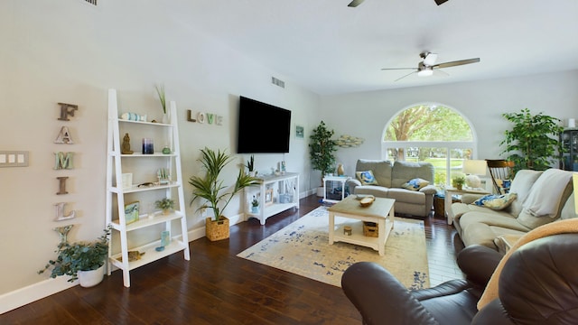 living room featuring a ceiling fan, visible vents, wood-type flooring, and baseboards