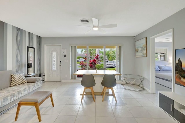 dining area with light tile patterned flooring, visible vents, baseboards, and ceiling fan
