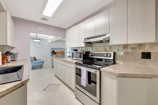 kitchen with decorative backsplash, appliances with stainless steel finishes, under cabinet range hood, and light tile patterned floors