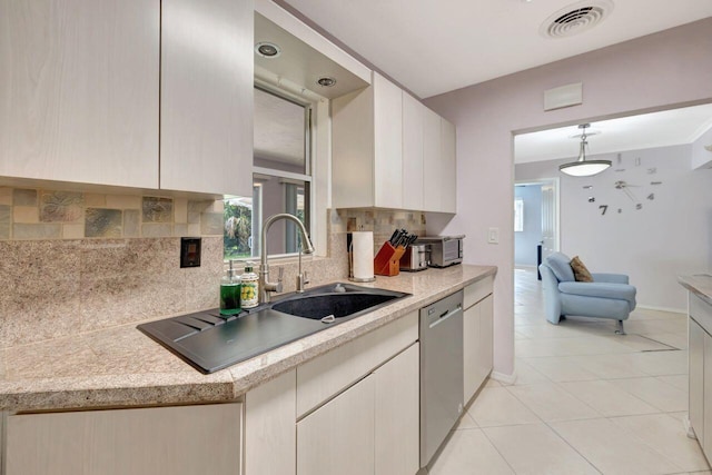 kitchen featuring light countertops, dishwasher, visible vents, and a sink