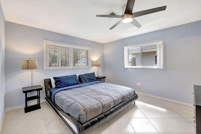 bedroom featuring ceiling fan, baseboards, and light tile patterned floors