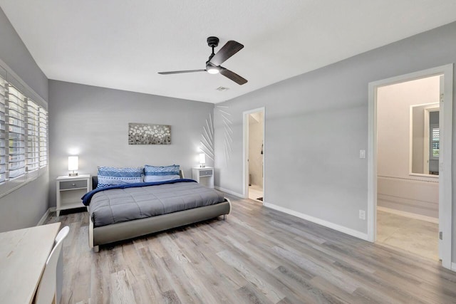 bedroom with baseboards, ensuite bathroom, wood finished floors, and ceiling fan
