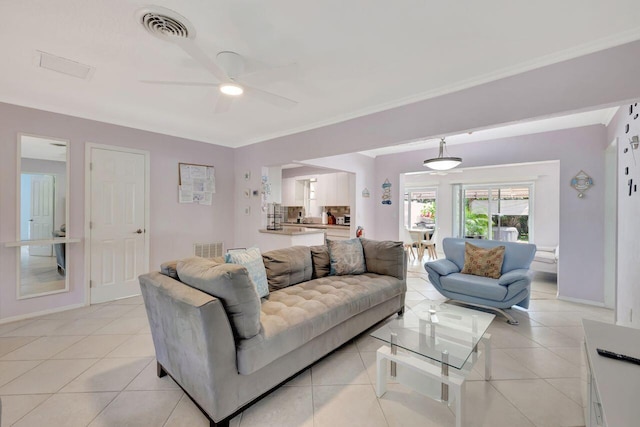 living room with light tile patterned floors, visible vents, and ceiling fan