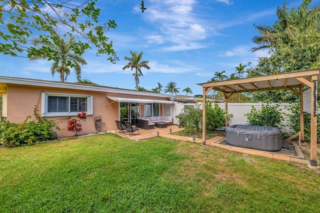 rear view of house featuring fence, a patio area, a yard, stucco siding, and an outdoor living space