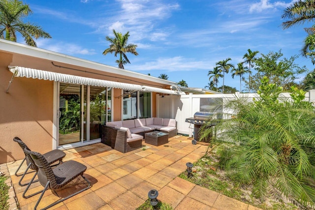 view of patio featuring fence, an outdoor living space, and a grill