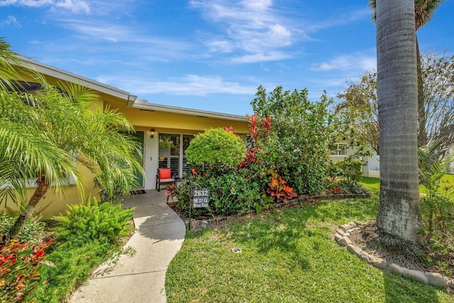 entrance to property with a yard