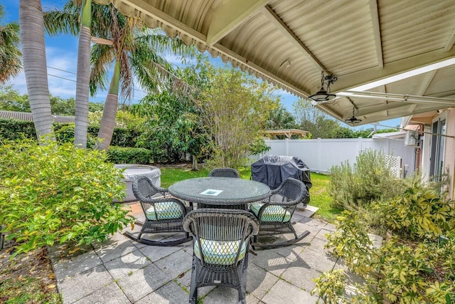 view of patio / terrace with outdoor dining area, fence, central air condition unit, and grilling area