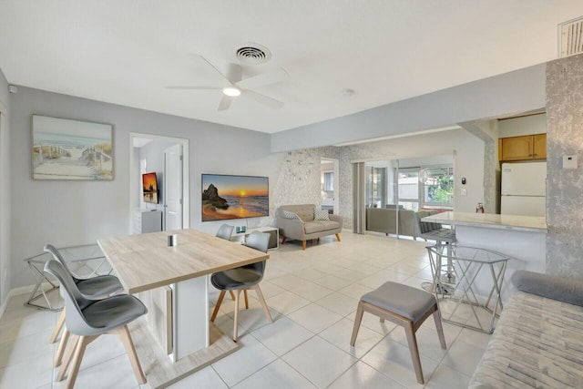 dining area featuring light tile patterned floors, baseboards, visible vents, and ceiling fan