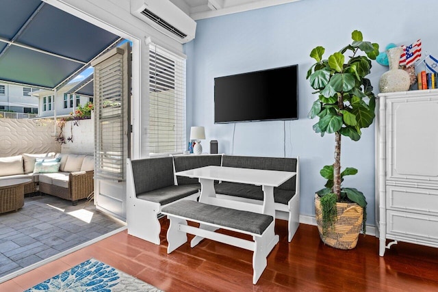 interior space featuring wood finished floors and a wall mounted AC