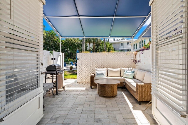 view of patio featuring an outdoor hangout area, a grill, and fence