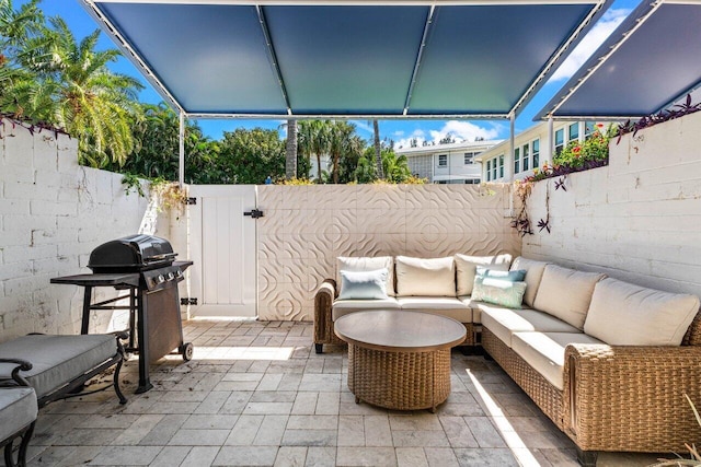 view of patio / terrace featuring an outdoor living space, a fenced backyard, and a grill