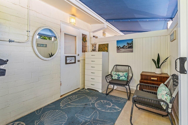 sitting room with brick wall