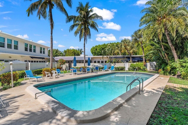 view of swimming pool with a fenced in pool, a patio, and fence