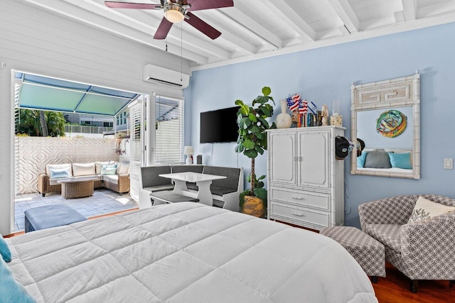 bedroom with ceiling fan, beam ceiling, wood finished floors, and a wall mounted AC