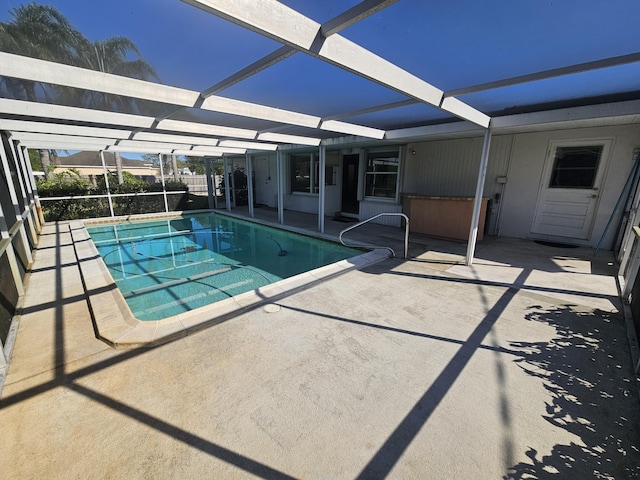 pool with a lanai and a patio area