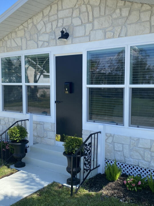 property entrance with stone siding