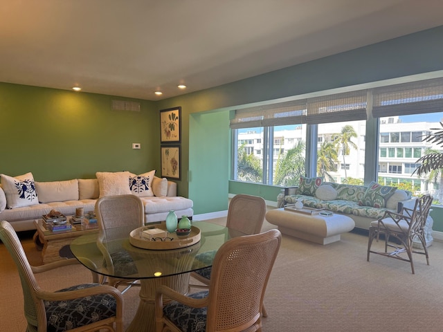 carpeted living area with recessed lighting and baseboards