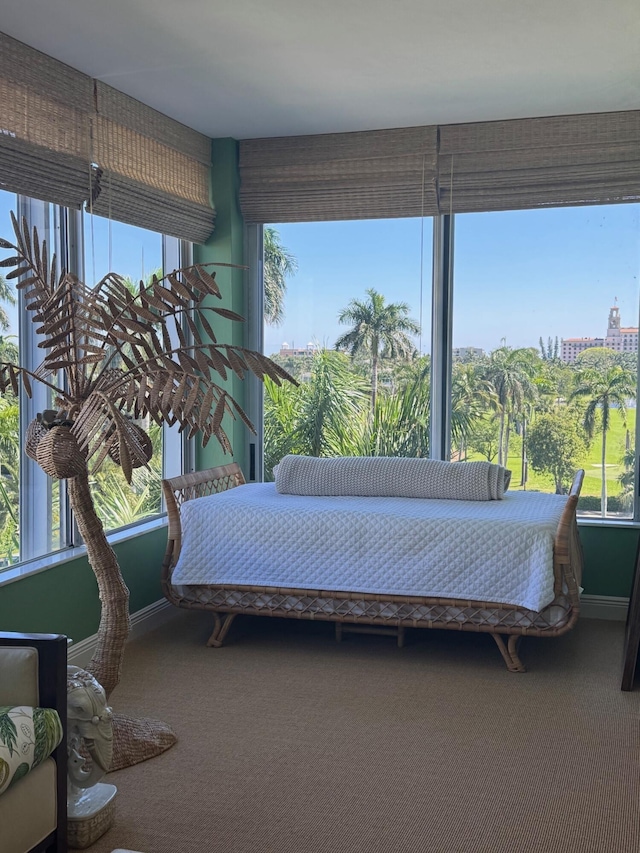 carpeted bedroom featuring multiple windows