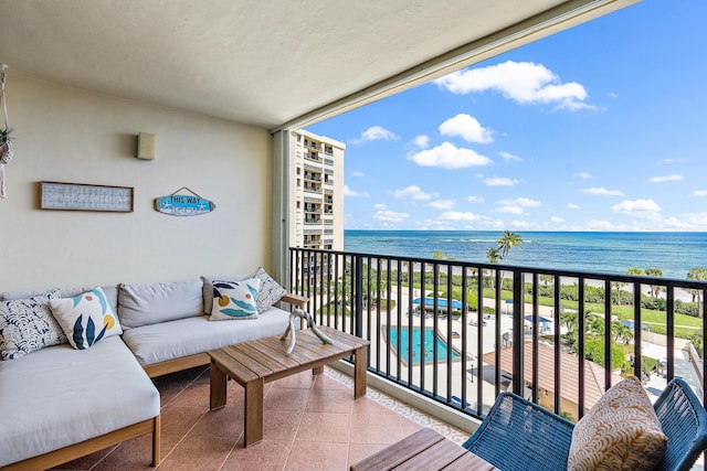 balcony featuring an outdoor living space, a beach view, and a water view