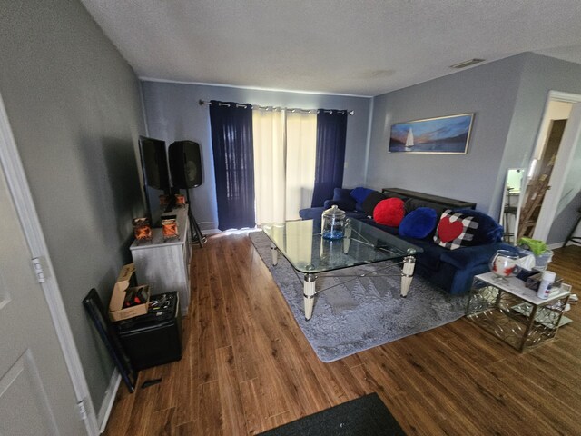 217 SE Village Dr Unit 217, Port Saint Lucie, FL 34952 - living room with a textured ceiling, visible vents, and wood finished floors