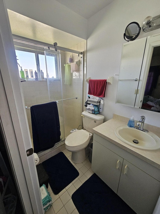 217 SE Village Dr Unit 217, Port Saint Lucie, FL 34952 - full bathroom with toilet, tile patterned floors, vanity, and a stall shower