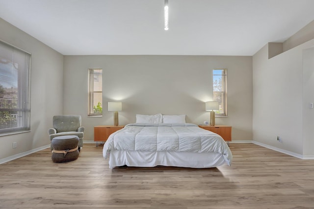 bedroom featuring baseboards and wood finished floors