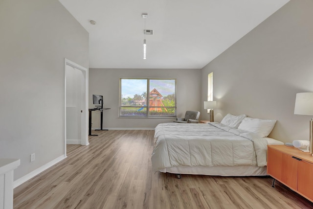 bedroom featuring visible vents, light wood-type flooring, and baseboards