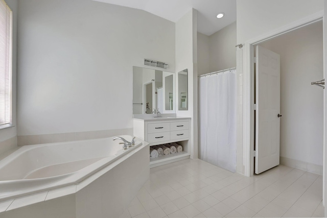 bathroom featuring vanity, vaulted ceiling, curtained shower, tile patterned floors, and a bath