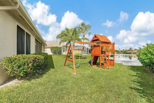 view of playground with a water view and a lawn