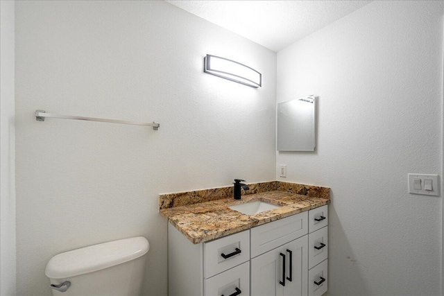 half bath with vanity and toilet