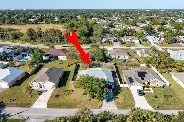 birds eye view of property with a residential view