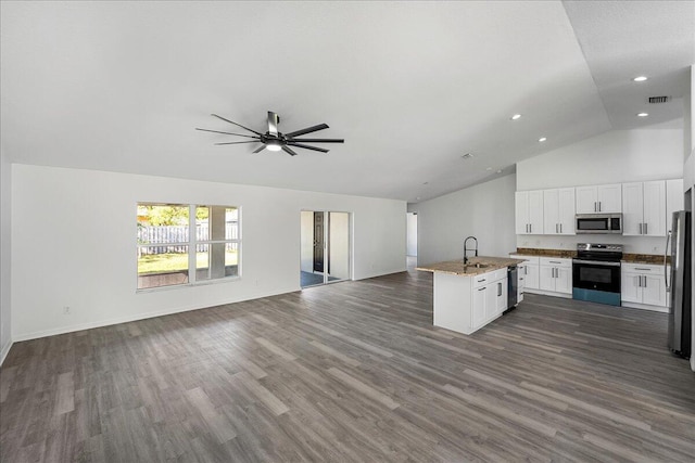 kitchen featuring white cabinetry, dark wood-style floors, open floor plan, and stainless steel appliances