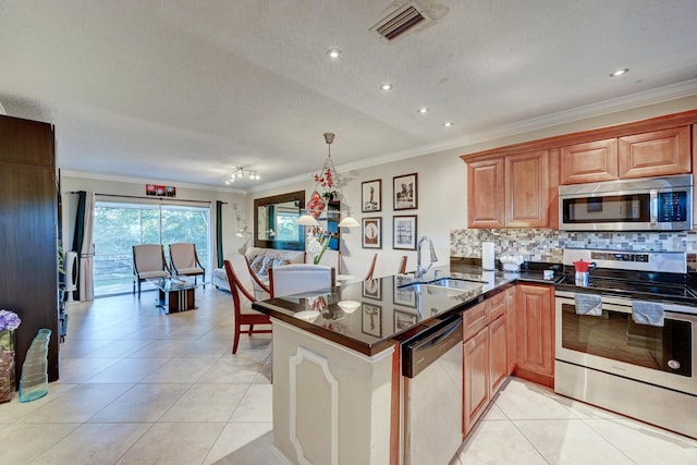 kitchen with light tile patterned floors, appliances with stainless steel finishes, tasteful backsplash, and a sink