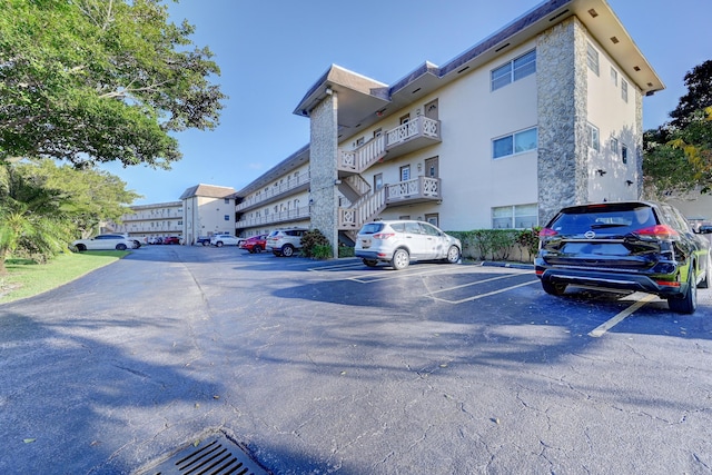 view of building exterior with uncovered parking