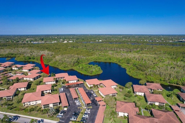 bird's eye view with a forest view, a water view, and a residential view