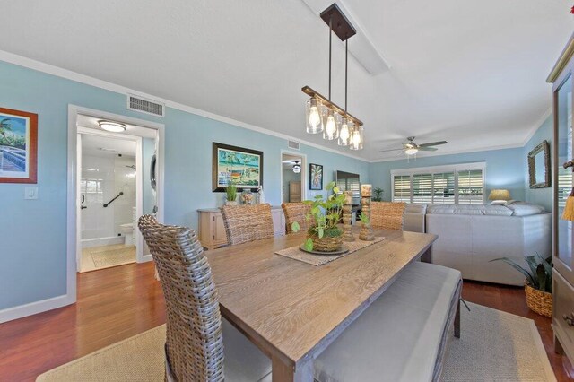 dining space featuring crown molding, baseboards, visible vents, and dark wood-style flooring